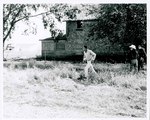 F08_E07_01 Gordon Parks, Jr. walking in front of the house used on location during the filming of "The Learning Tree" on location in Bourbon and Linn counties, Kansas by Unknown