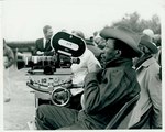 F10_E10_02 Gordon Parks sits behind a movie camera on location for "The Learning Tree" in Bourbon and Linn counties, Kansas by Unknown