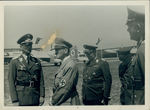 Adolf Hitler (second from left) talking to a German Luftwaffe officer and Hermann Goering (third from left) by Unknown