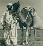 North African man and a camel by Unknown